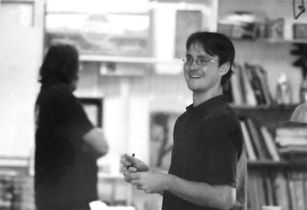 A black and white photograph of artist and arts administrator Shea Little.