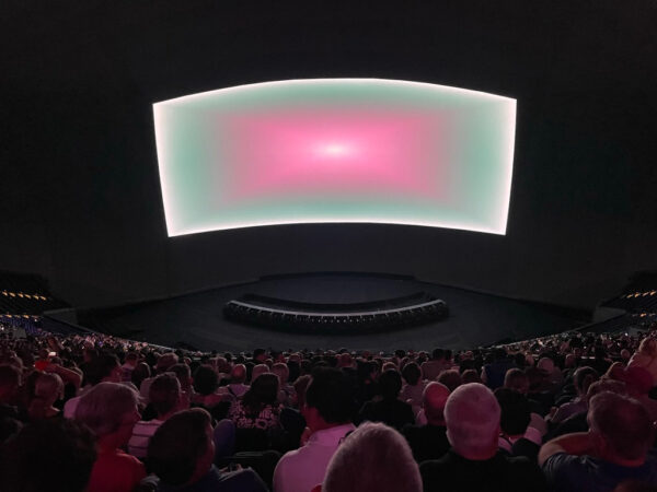 Projection of pink and green light inside of the Sphere in Las Vegas
