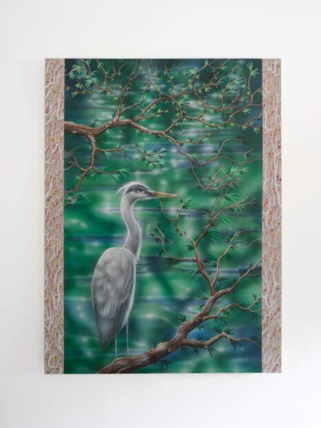Photo of a painting of a white crane against a green backdrop