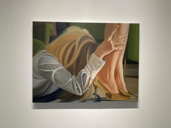 A painting of a blonde women on the floor, holding onto the ankles of another woman that is standing.