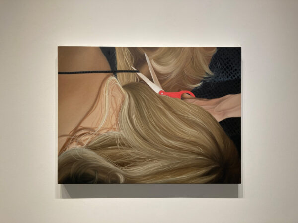 A painting of a blonde woman laying face-down with her hair being cut by red scissors.