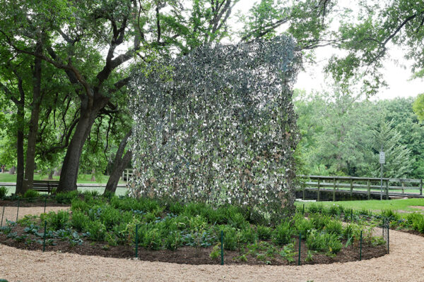 A photograph of a public art work by Alyson Shots featuring thousands of small stainless steel circles.