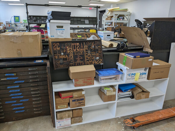 A photograph of boxes and stored items from The Printing Museum.