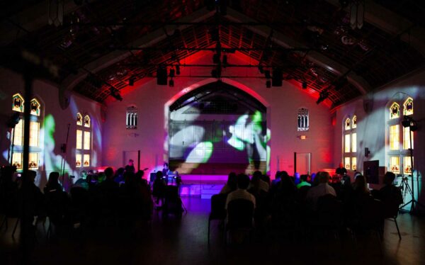 Performances are projected on to the back wall of an old church.