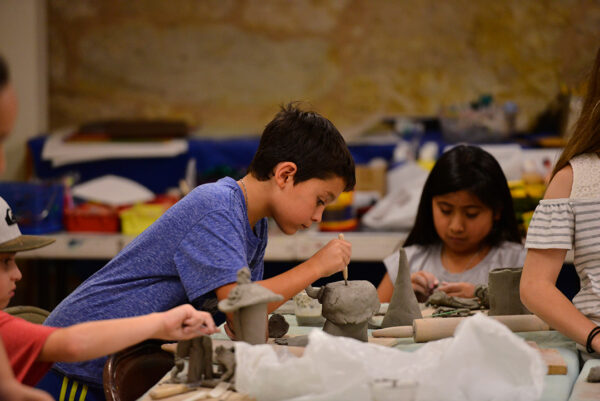 A photograph of students engaging in an art making workshop.