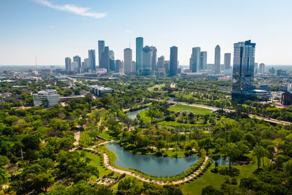 A photograph of a green space at the edge of Houston with the city's skyline in the distance.