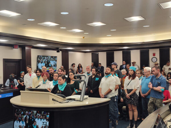 A photograph of Laredo artists and arts professionals gathered to speak at a City Council meeting.