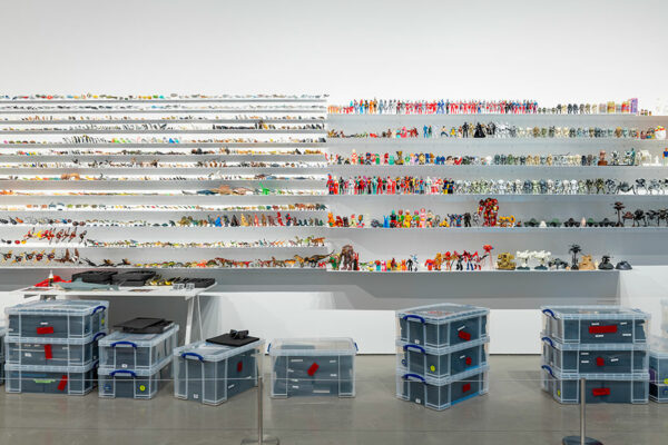 A wall of shelves host hundreds of colorful toy figurines.