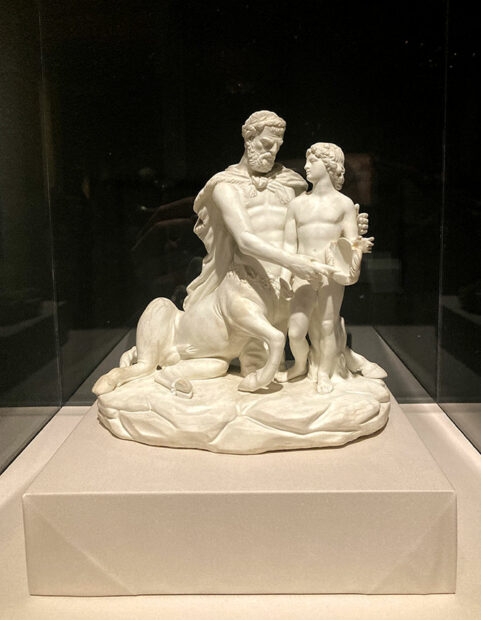 A small carved marble sculpture depicting a centaur and a young boy.