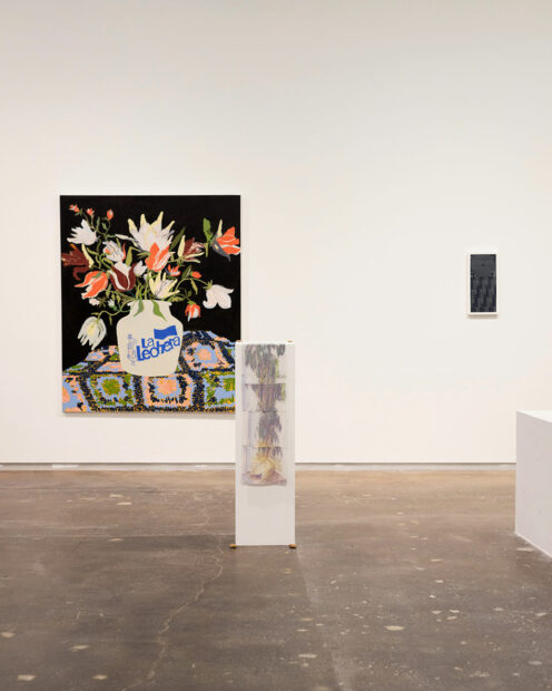 A gallery displays large paintings of flower vases and sculptures.