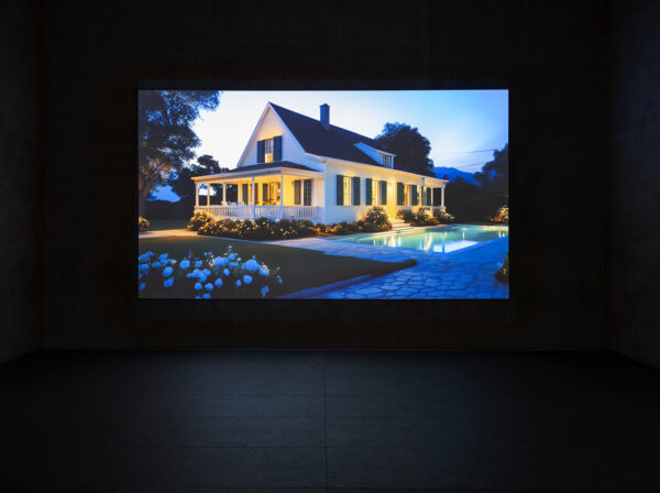 A still image of a large home with an outdoor pool from a video work by Laurie Simmons.