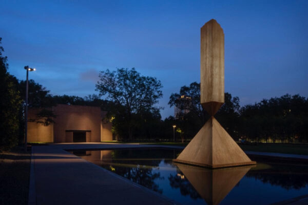 A nighttime photograph of the exterior of the Rothko Chapel.