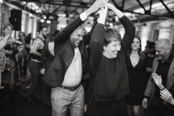 A black and white photograph of Terri Thornton with a crowd of people at a wedding.