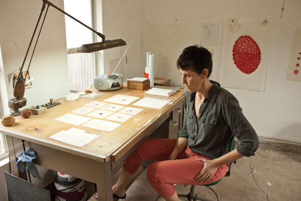 A photograph of artist Terri Thornton in her studio.