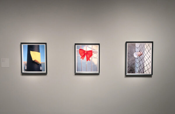 Three small framed photographs depicting quotidian images.