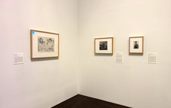 A gallery with three framed works on its walls.