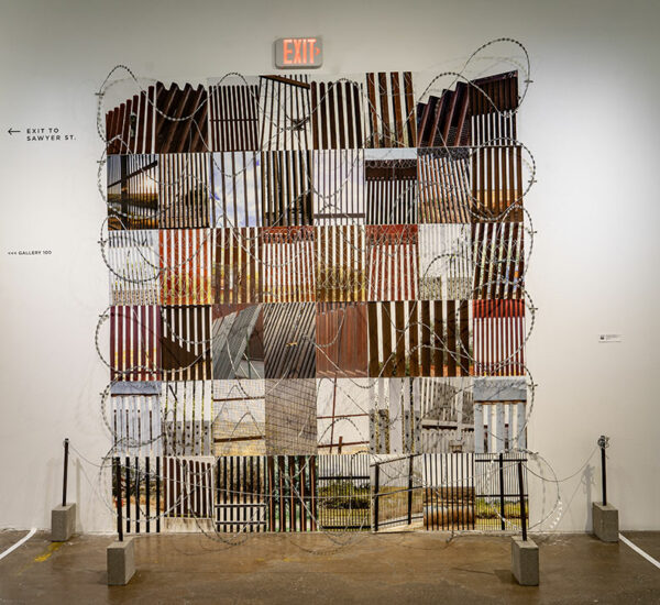 A collection of photographs of different sections of the border wall installed with razor wire in a gallery.