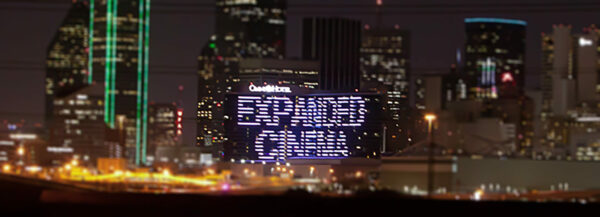 An image of text on a downtown Dallas building that reads, "Expanded Cinema."