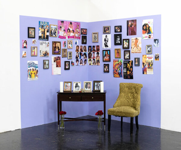 Dozens of photographs are installed on a gallery wall and made to look like a domestic installation.