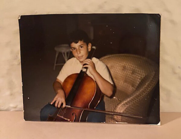 A photograph of artist Robert Rosenberg as a child playing a cello.