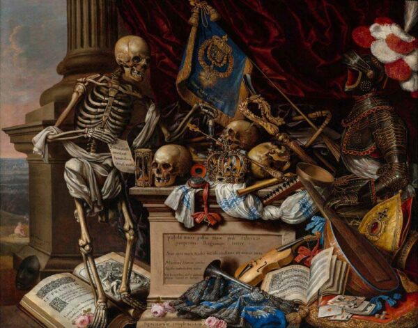 A skeleton stands next to a handful of skulss and books, and clothes, and banners in a pile.