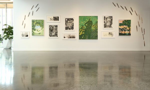 An installation image of artworks by four artists on a white gallery wall.