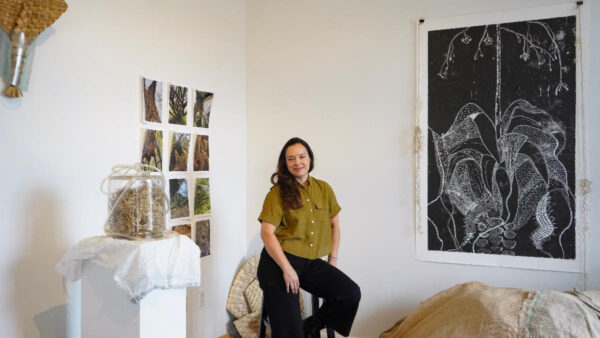 A photograph of artist Zulma Vega in her studio at Lawndale.