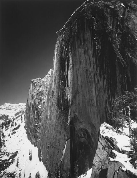 A highly detailed black and white photograph of a snow covered mountain.