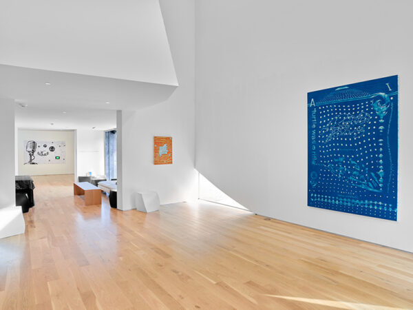 A large gallery featuring a blue abstract painting on its walls.