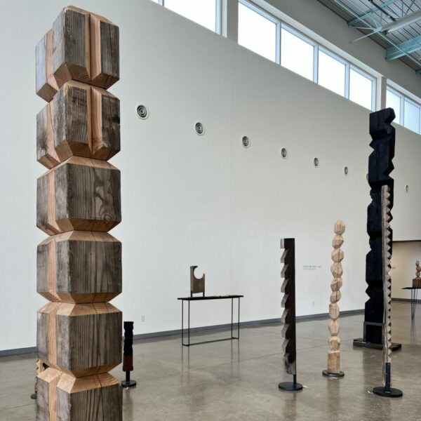 An installation image of wood sculptures by Chad Plunket.