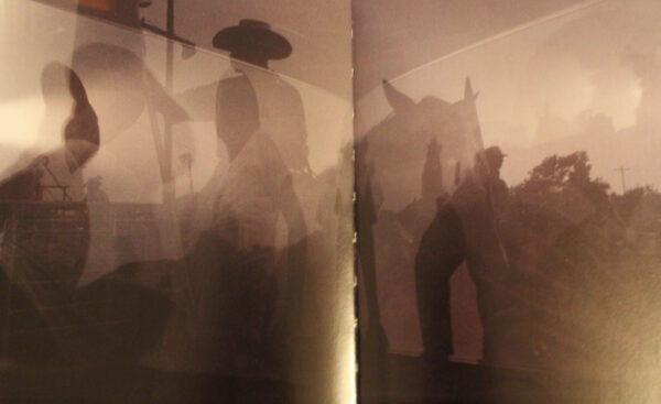 A projection of silhouetted cowboys.