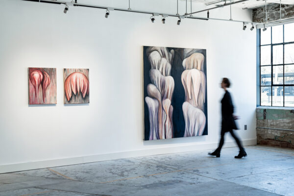 An installation photograph of abstract organic paintings by Erika Jaeggli.