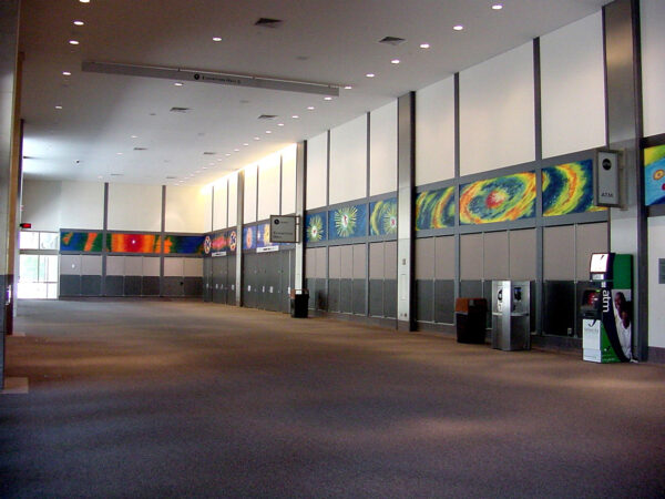 An installation image depicting mural panels by Rolando Briseño at the Austin Convention Center.