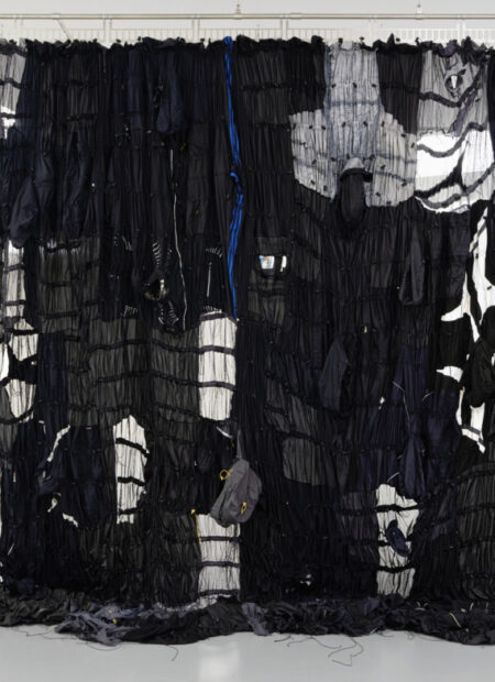 A large hanging fabric piece made of sportswear garments.