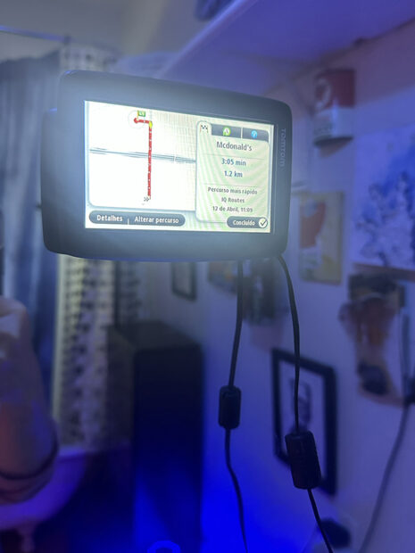 A photograph of a gps device with directions to a McDonald's restaurant.