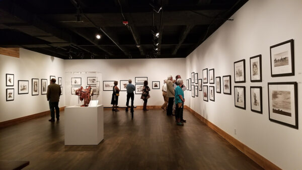 A photograph of people in a gallery.