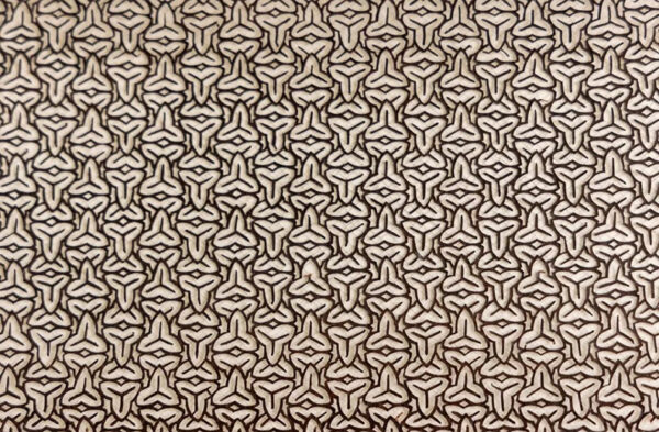 An intricately patterned stencil.