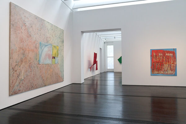 A museum houses several large canvases in multiple rooms.