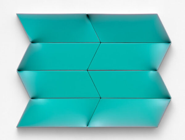 A photograph of a geometric shaped canvas painted blue.
