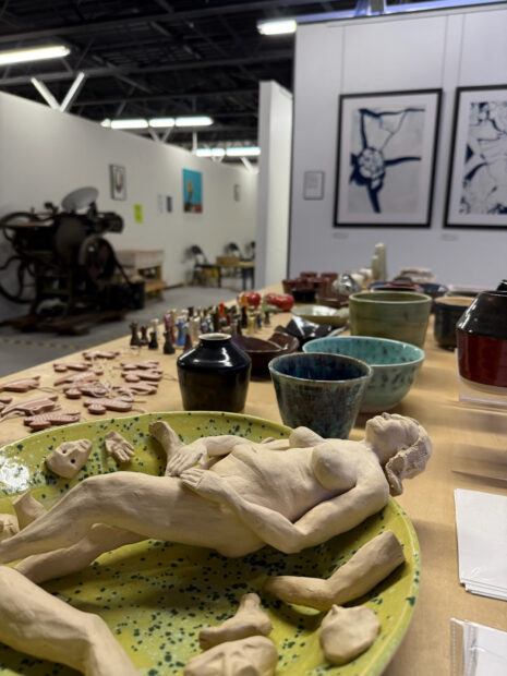 A photograph of a table filled with small ceramic pieces.
